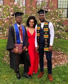 Jonady St. Germain and Darren Stephens pose for a photo in their BSU graduation attire.