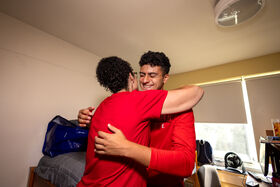 A mom hugs her son
