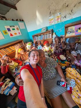 A woman takes a selfie in a classroom