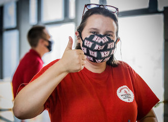 Student gives a thumbs up while smiling