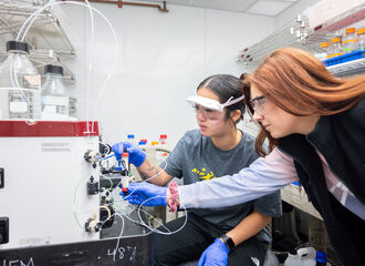 2 students using equipment in Chemistry Lab