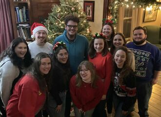 A group of people stand together smiling at the camera