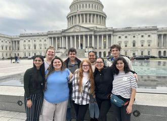 A group stands in front of the capital building in washington dc