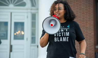 Brandie Leach speaks to the crowd from the steps of Boyden