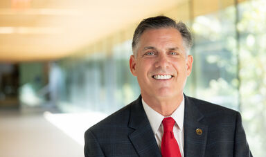 President Clark stands in a long hallway.