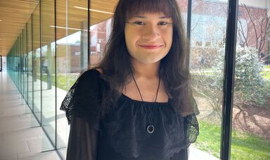 A woman wearing black smiles for the camera
