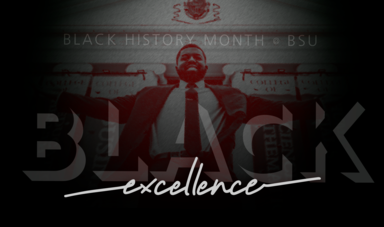 A man stands behind the words &quot;excellence&quot;