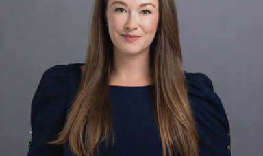 A woman with long brown hair poses for the camera