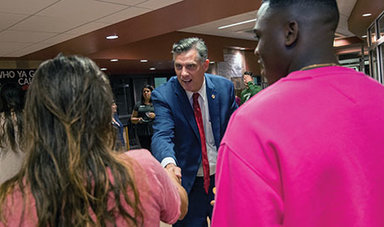 President Clark shakes hands with students