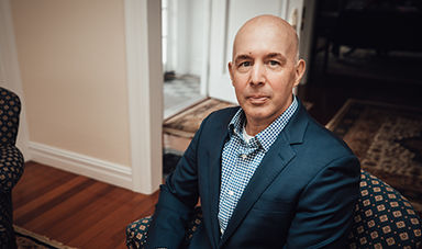 Robert Cozzone sits in a chair.
