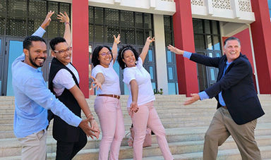 Fred Clark and four BSU alumni who are professors in Cape Verde pose with outstretched arms