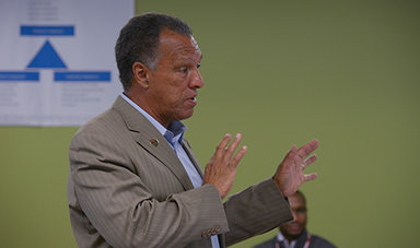 Dana Mohler-Faria makes a point using his hands while giving a speech.