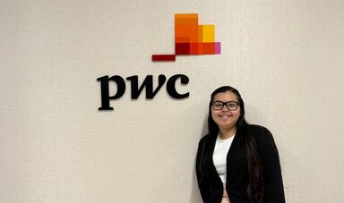 Glendys Bonilla stands next to the PwC logo.