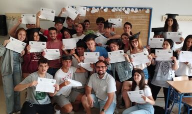 A man sits in the middle of a group of students