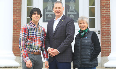 Peter Koutoujian, '25, Peter J. Koutoujian, '83 and Connie Koutoujian stand on steps of Boyden Hall