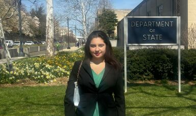 A student stands outside of the Department of State