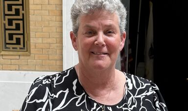 a woman with gray hair smiles