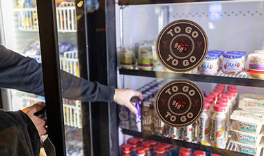 A student picks a drink out of a Bears-to-Go refirgerator.