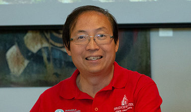 Dr. Wing-kai To smiles while posing for a photo.