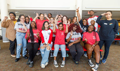 A group of students making silly poses for the camera together at a LGCIE event