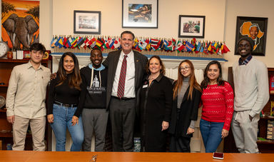 International students smiling with BSU President Fred Clark at an event
