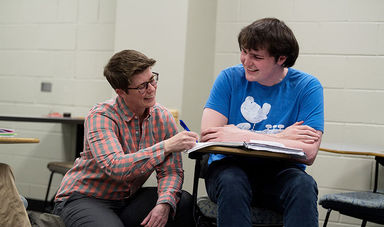 Professor Meghan Murphy works with a student in a sociology class