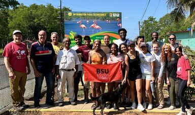 BSU students in Cuba holding up a BSU Study Abroad banner