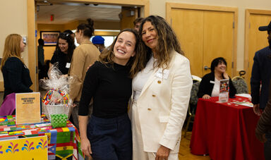 Two women smiling for the camera at the Global Engagement Day celebration