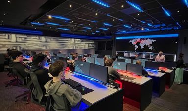 A class of high school students sitting at computer workstations in BSU's cyber range