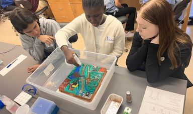 3 students engage in a watershed modeling activity