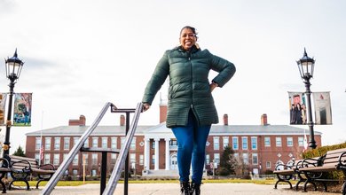 Dr. Wendy Williams stands on top of stairs near Boyden Hall