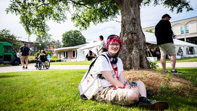 New Student Checkpoint - student sitting under tree
