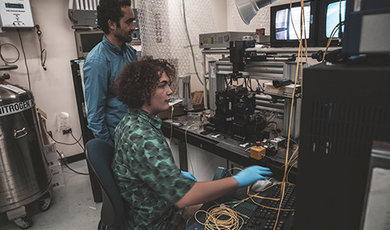 Dr. Samuel Serna and Brahmin Thurber-Carbone work in a lab a