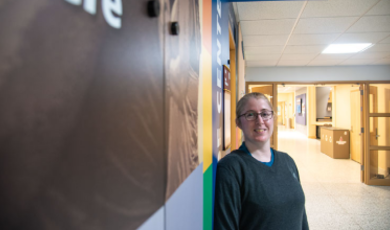 Carolyn Daggart, Pride Center Director standing in hallway 