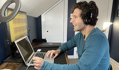 Dr. Kevin Duquette works on a computer in his home office.