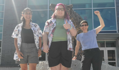 Cristina Dudziak, Elliot Philie and Lee Forest in front of bronze bear statue