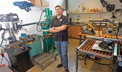 Robert Monteith, analytical instrumentation engineer, stands inside the Academic Machine Shop. 