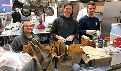 Marissa Morganelli, '19, along with fellow seniors Parker Smith (left) and Jason Silva, help prepare meals for the homeless in Washinton, D.C.,during a spring Alternative Break Trip.