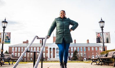 Dr. Wendy Williams stands on top of stairs near Boyden Hall