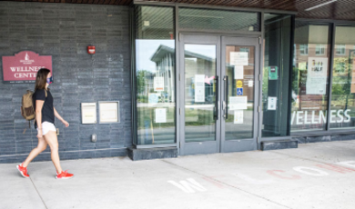 a student walks outside of wellness center