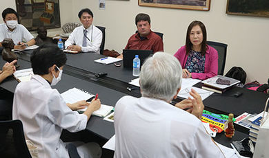 BSU and Japanese researchers sit at a conference table.