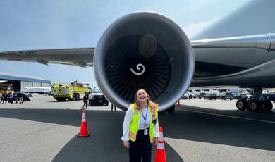 Sophia Schiappa stands in front of a large jet engine.