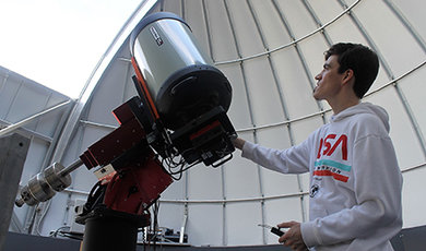 Antu Stettler adjusts a telescope in BSU's observatory.