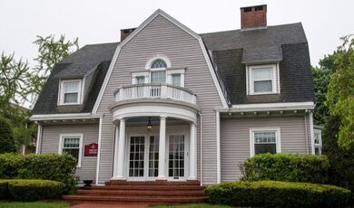Exterior of the Barry House with brick steps and landscaping in front.