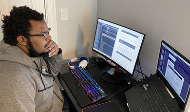 Jahmel Wint works at a computer desk.
