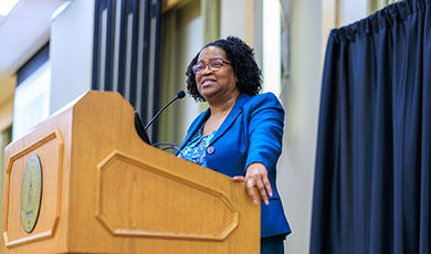 Jeanean Davis-Street speaks while standing behind a podium.