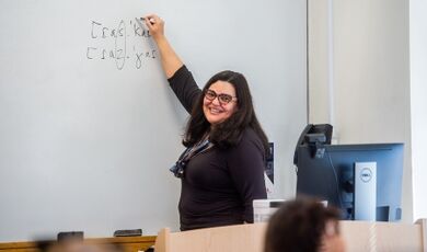 Fernanda Ferreira writes on a white board while teaching a class.