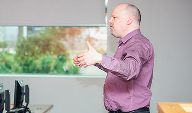 Brian Frederick teaches a class in a computer lab.