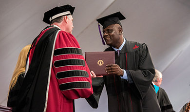 A student receives his diploma.