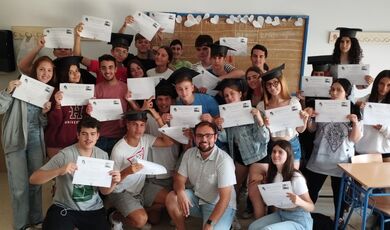 A man sits in the middle of a group of students